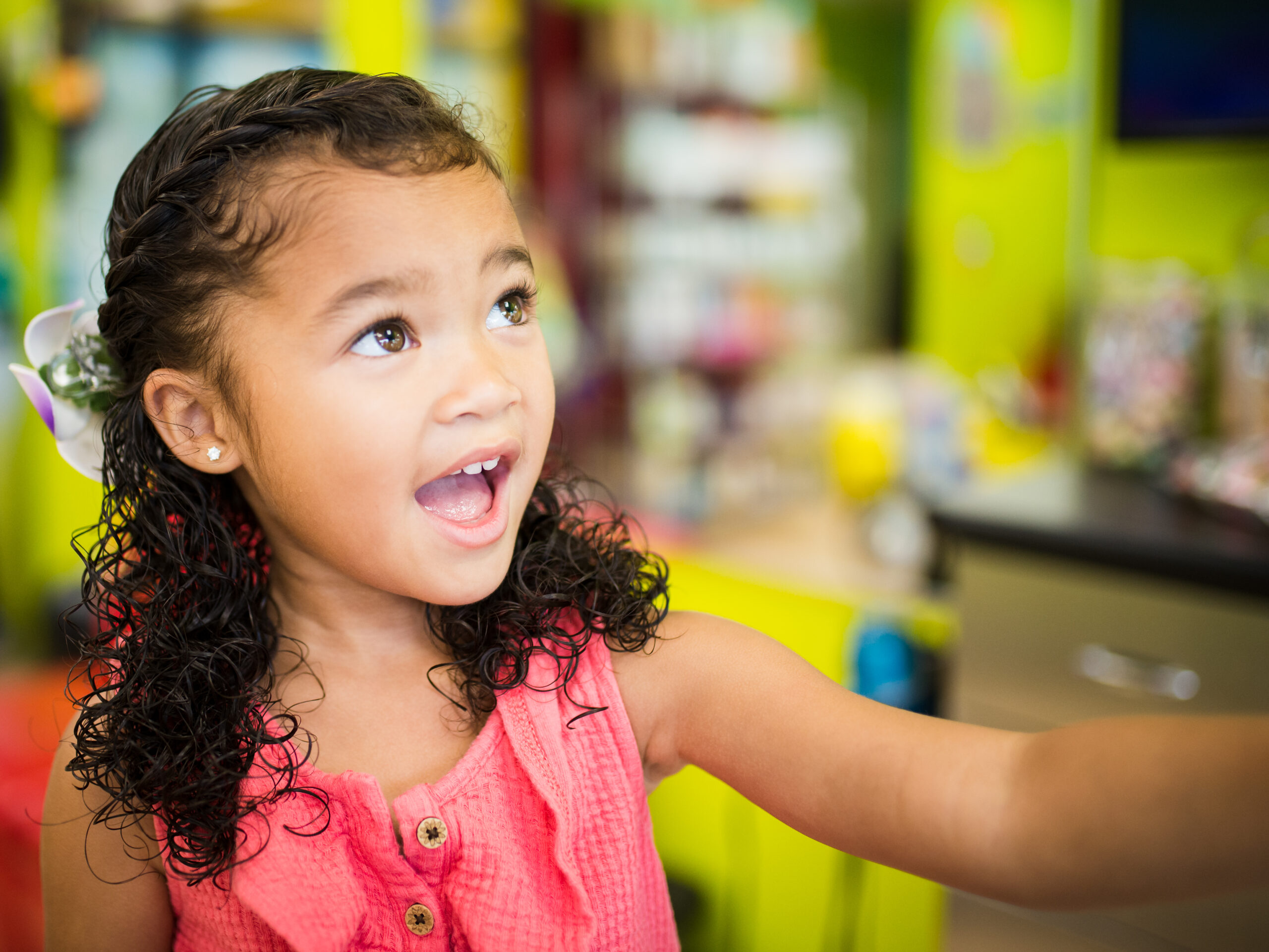 Smiling girl with her ear pierced - Pigtails & Crewcuts Buckhead