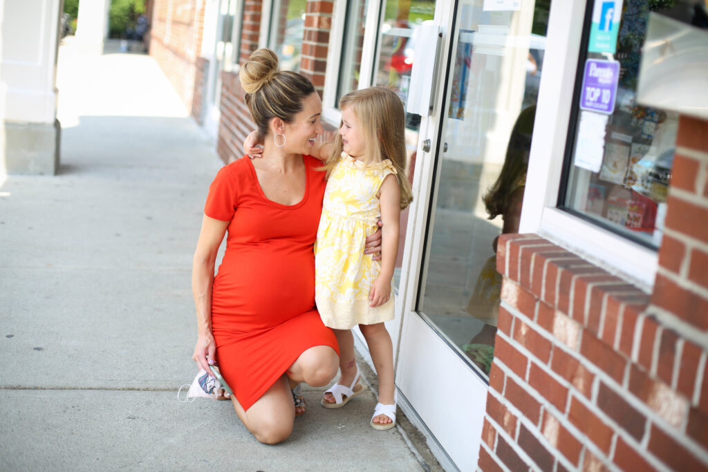 Mom and daughter smiling at each other outside of the salon - Pigtails & Crewcuts Buckhead