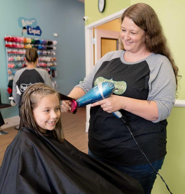 Pigtails & Crewcuts Stylist blow drying a little girls hair
