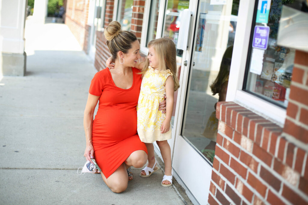 Mom and daughter hugging - Pigtails & Crewcuts Smyrna