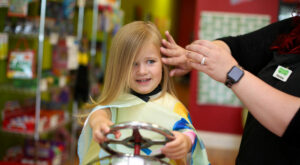 Girl getting her hair styled - Pigtails & Crewcuts Smyrna