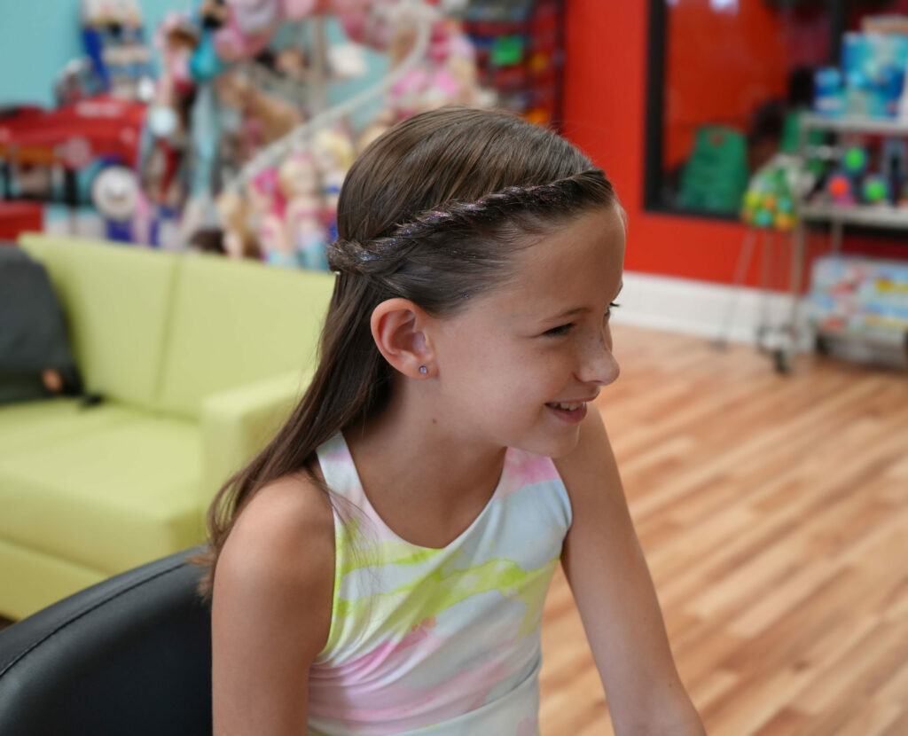 Smiling girl with braids at Pigtails & Crewcuts Smyrna/Vinings