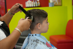 Boy getting haircut at Pigtails & Crewcuts Smyrna