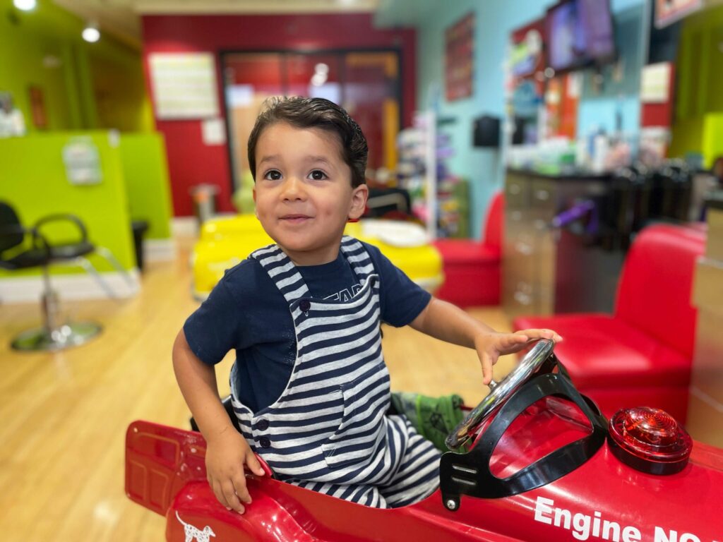 Smiling boy with dark hair - Pigtails & Crewcuts Smyrna