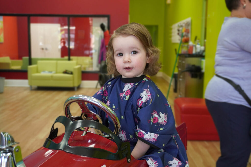 Curious little girl having fun at Pigtails & Crewcuts Buckhead.