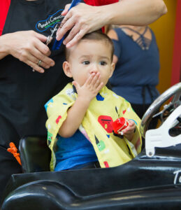 Expressive little boy getting a haircut at Pigtails & Crewcuts Greenville Augusta Road