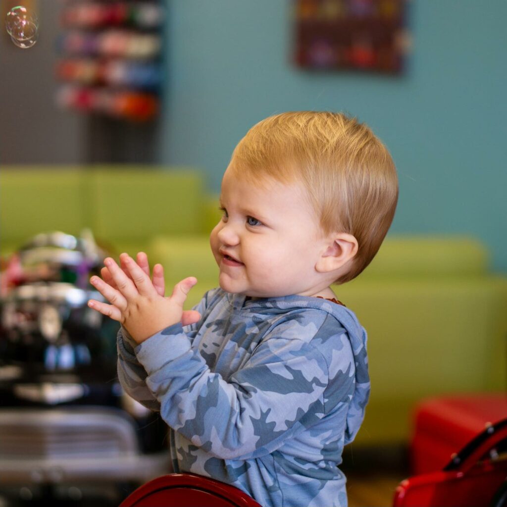 Happy, clapping little boy - Pigtails & Crewcuts Jacksonville