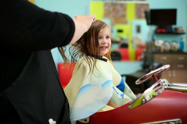 Smiling Girl gets her hair done - Pigtails & Crewcuts Jacksonville