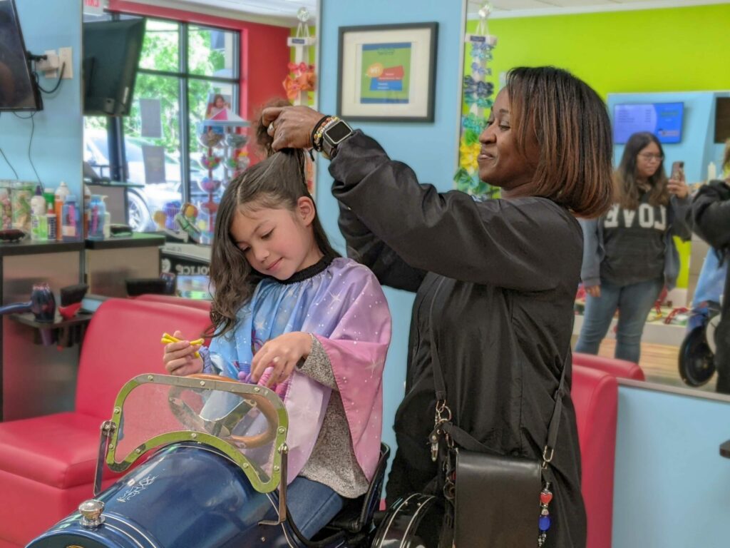Little girl getting hair styled - Pigtails & Crewcuts Jacksonville