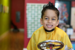 Smiling boy with spiky hair - Pigtails & Crewcuts Jacksonville
