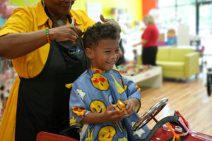 Little boy laughing during haircut - Pigtails & Crewcuts Jacksonville