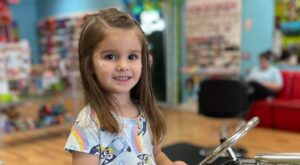 Girl happy with her haircut from Pigtails & Crewcuts East Memphis