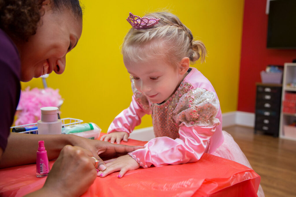 Girl getting her nails painting at Pigtails & Crewcuts