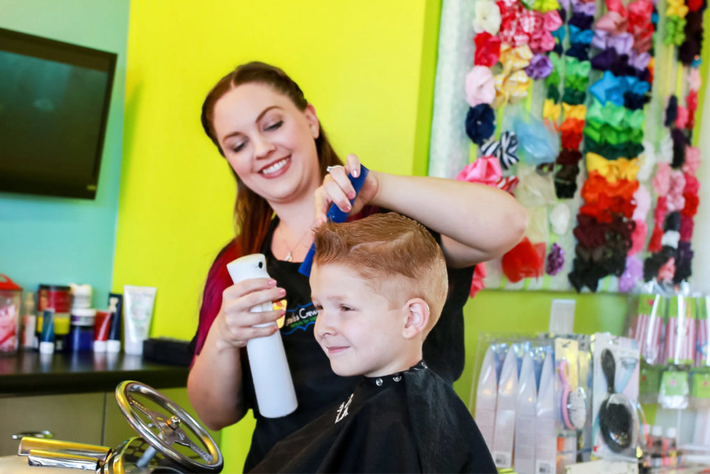 Stylist spraying a boy's hair - Feature Image