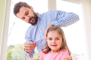 Dad styling his daughters hair