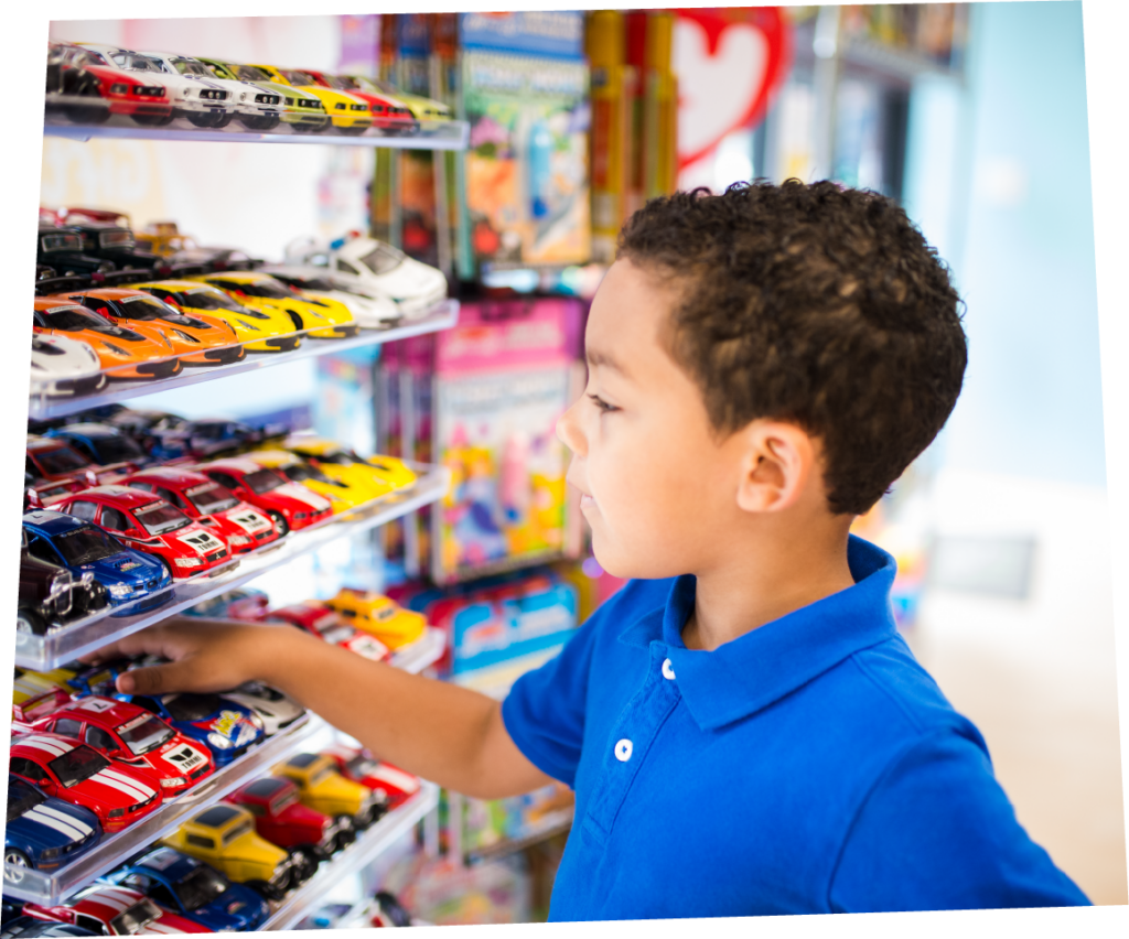 Boy looking at the toys and retail at Pigtails & Crewcuts