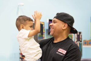 Dad and son excited after a cute haircut at Pigtails & Crewcuts